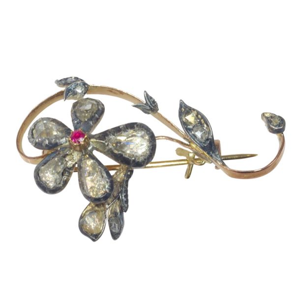 Victorian diamond and ruby brooch in gold and silver.