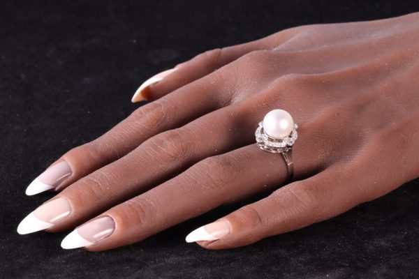 Art Deco pearl and old cut diamond ring in platinum.