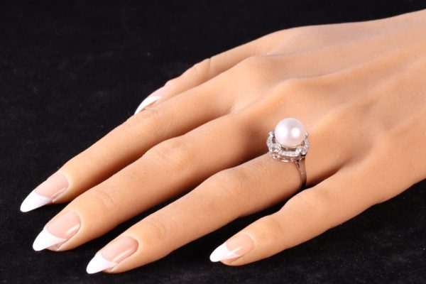 Art Deco pearl and old cut diamond ring in platinum.