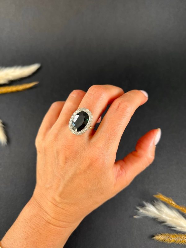 Antique sapphire and diamond cluster ring in gold and platinum.