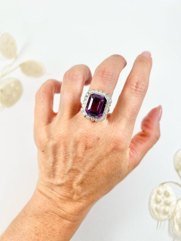 Antique amethyst and diamond cluster halo ring in white gold and platinum.