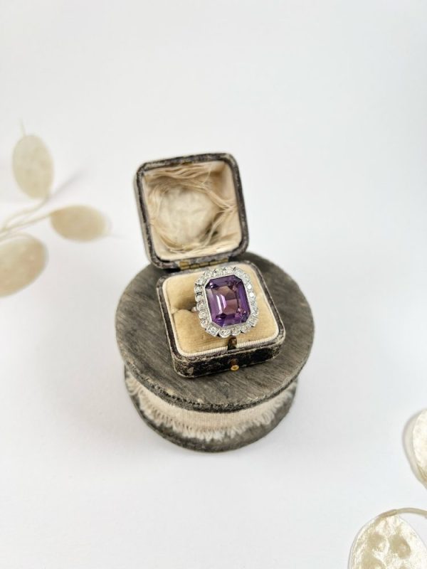 Antique amethyst and diamond cluster halo ring in white gold and platinum.