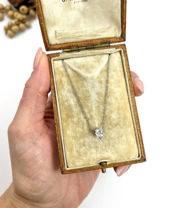 Diamond heart pendant necklace on platinum chain.