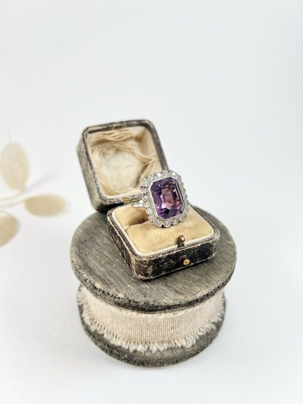 Antique amethyst and diamond cluster halo ring in white gold and platinum.