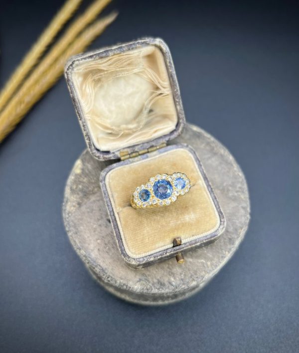 Sapphire and diamond triple daisy ring in gold,