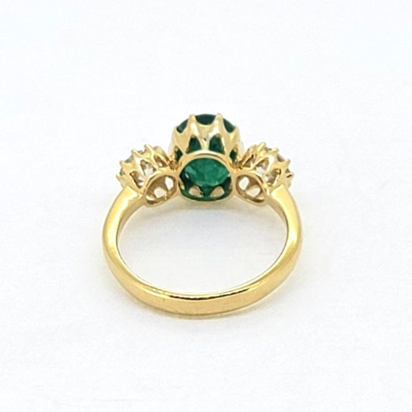 2.32ct Oval Emerald and Diamond Three Stone Trilogy Engagement Ring in 18ct Yellow Gold, 2.32 oval-cut green emerald flanked by 1cts round brilliant-cut diamonds