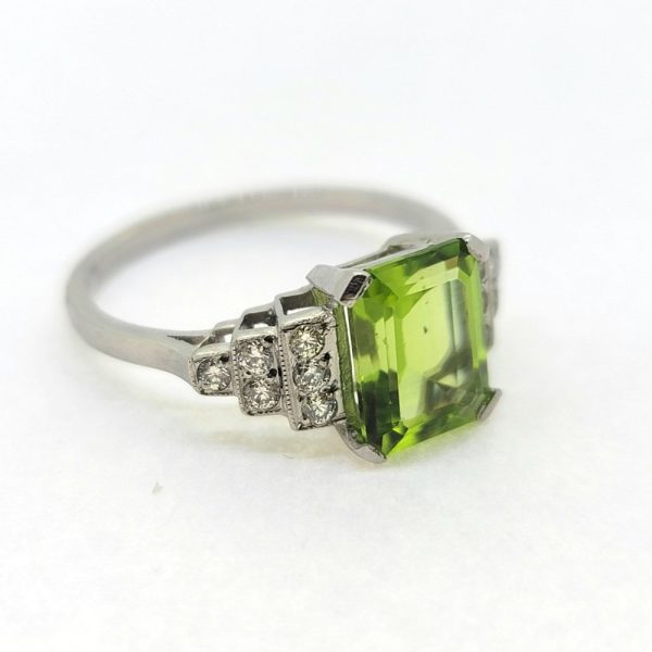 2.40ct Peridot and Diamond Engagement Ring in Platinum, 2.40ct emerald-cut peridot flanked by brilliant-cut diamond set stepped shoulders