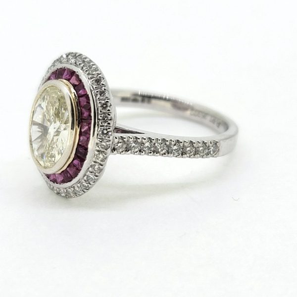 1.51ct Fancy Yellow Diamond and Ruby Cluster Ring in Platinum, VS oval 1.51ct fancy yellow diamond surrounded by halo of rubies within outer border of white diamonds