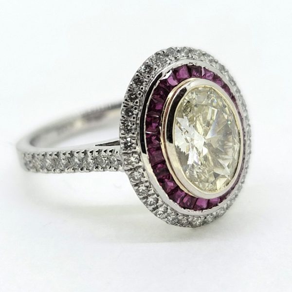 1.51ct Fancy Yellow Diamond and Ruby Cluster Ring in Platinum, VS oval 1.51ct fancy yellow diamond surrounded by halo of rubies within outer border of white diamonds