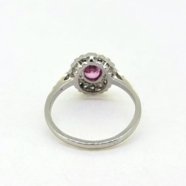 0.80ct Pink Sapphire and Diamond Cluster Engagement Ring in Platinum, 0.80ct oval pink sapphire surrounded by 0.40cts sparkling diamonds in timeless floral cluster design