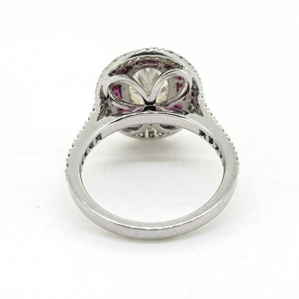 1.51ct Fancy Yellow Diamond and Ruby Cluster Ring in Platinum, VS oval 1.51ct fancy yellow diamond surrounded by halo of rubies within outer border of white diamonds