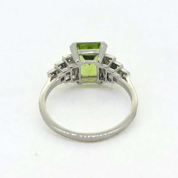 2.40ct Peridot and Diamond Engagement Ring in Platinum, 2.40ct emerald-cut peridot flanked by brilliant-cut diamond set stepped shoulders
