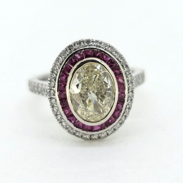 1.51ct Fancy Yellow Diamond and Ruby Cluster Ring in Platinum, VS oval 1.51ct fancy yellow diamond surrounded by halo of rubies within outer border of white diamonds