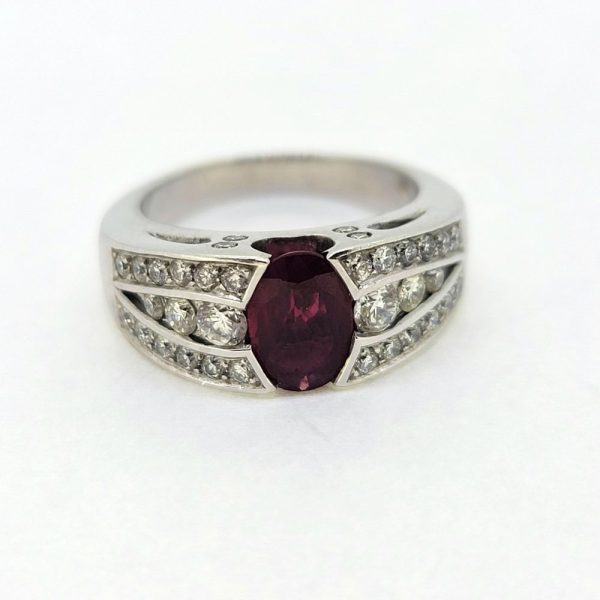 Romain Herzo 1ct Ruby and Diamond Ring, 1ct oval red ruby flanked by three row split diamond shoulders in 18ct white gold