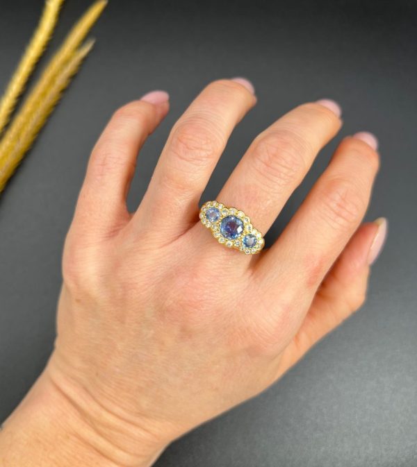 Sapphire and diamond triple daisy ring in gold,