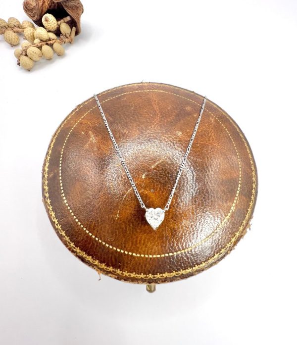 Diamond heart pendant necklace on platinum chain.
