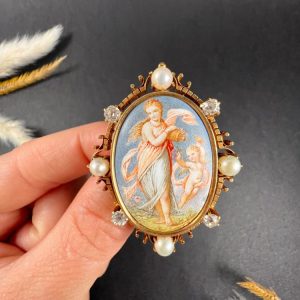 Antique enamel, pearl and diamond portrait brooch in gold.