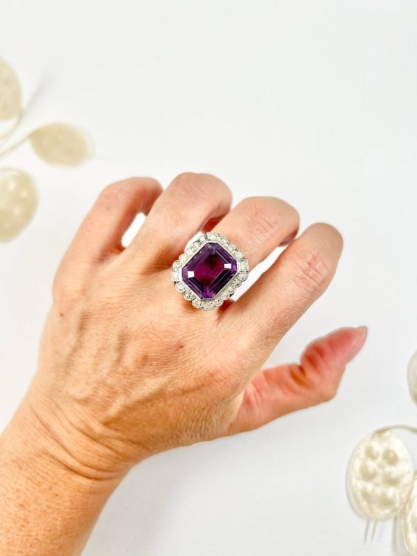 Antique amethyst and diamond cluster halo ring in white gold and platinum.