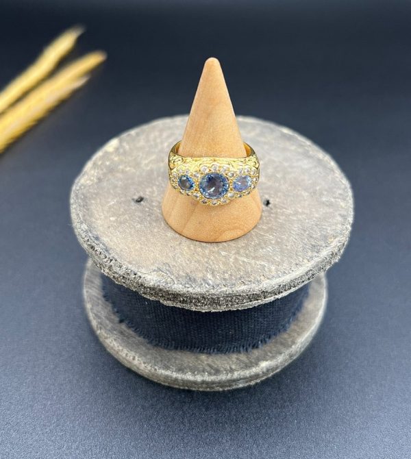 Sapphire and diamond triple daisy ring in gold,