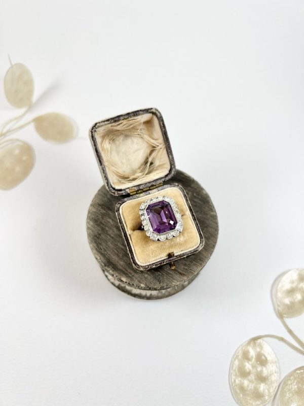 Antique amethyst and diamond cluster halo ring in white gold and platinum.