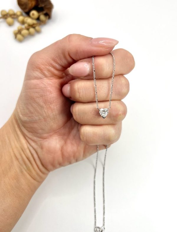 Diamond heart pendant necklace on platinum chain.