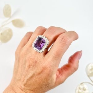 Antique amethyst and diamond cluster halo ring in white gold and platinum.