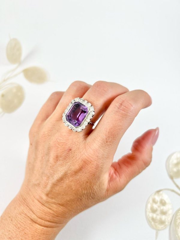 Antique amethyst and diamond cluster halo ring in white gold and platinum.