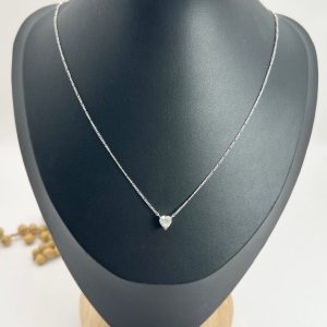 Diamond heart pendant necklace on platinum chain.