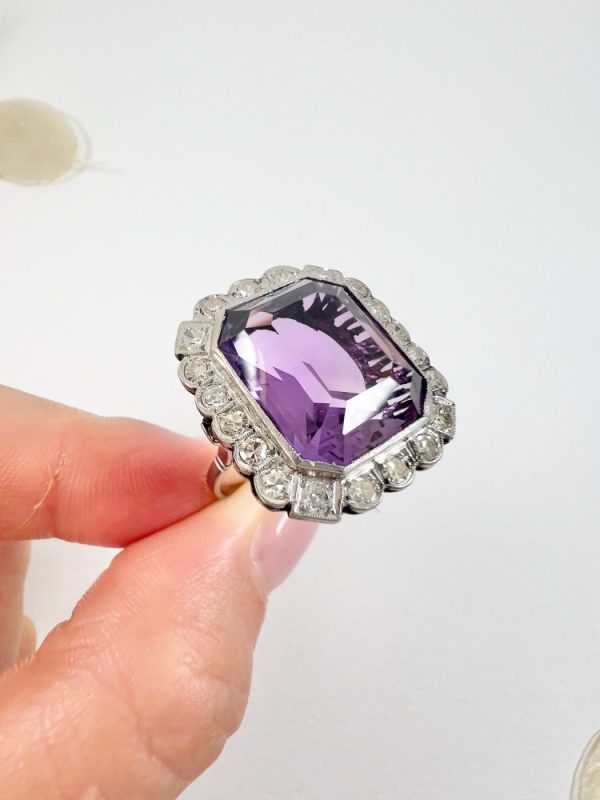 Antique amethyst and diamond cluster halo ring in white gold and platinum.