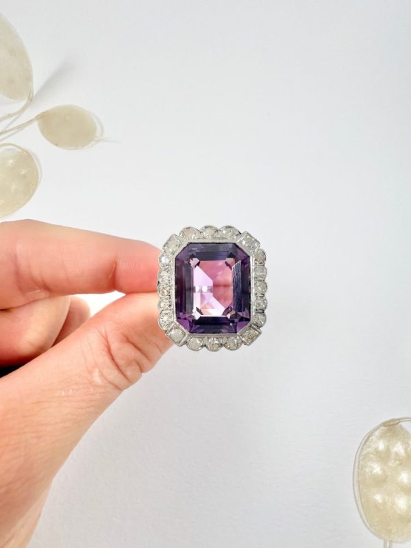 Antique amethyst and diamond cluster halo ring in white gold and platinum.