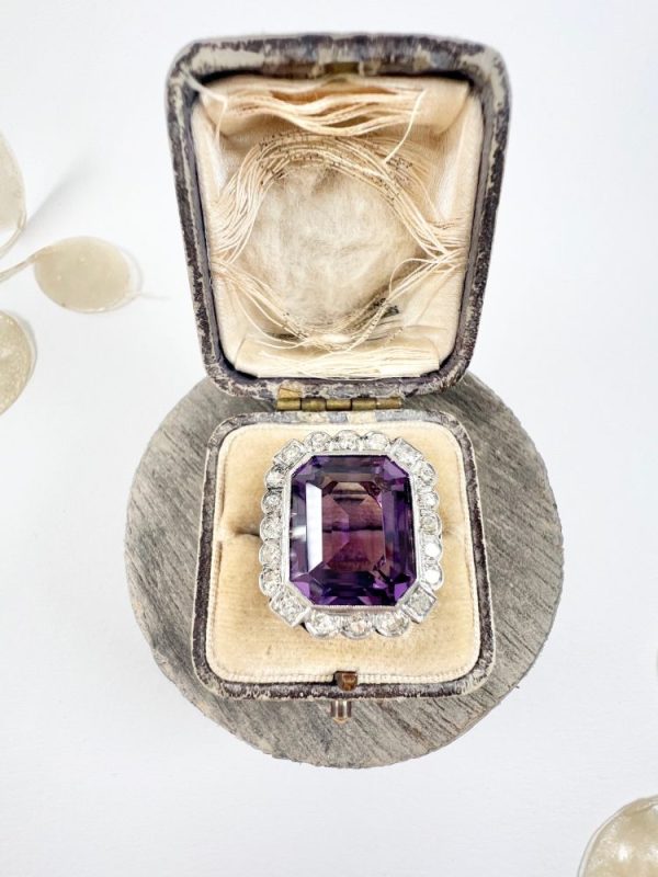 Antique amethyst and diamond cluster halo ring in white gold and platinum.