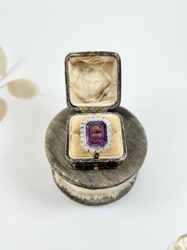 Antique amethyst and diamond cluster halo ring in white gold and platinum.