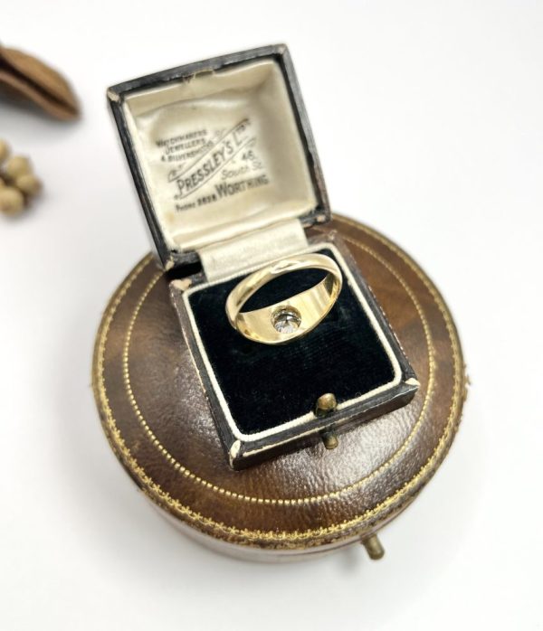 Antique gold gypsy band ring with single diamond.