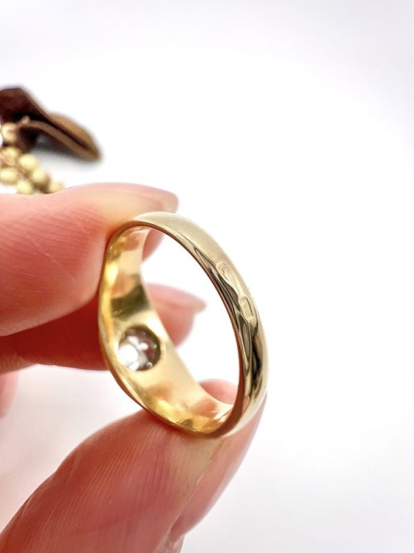 Antique gold gypsy band ring with single diamond.