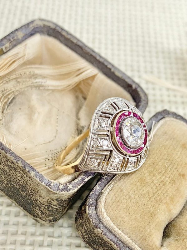Art Deco diamond and ruby target ring in yellow and white gold.
