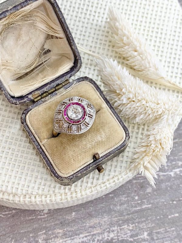 Art Deco diamond and ruby target ring in yellow and white gold.