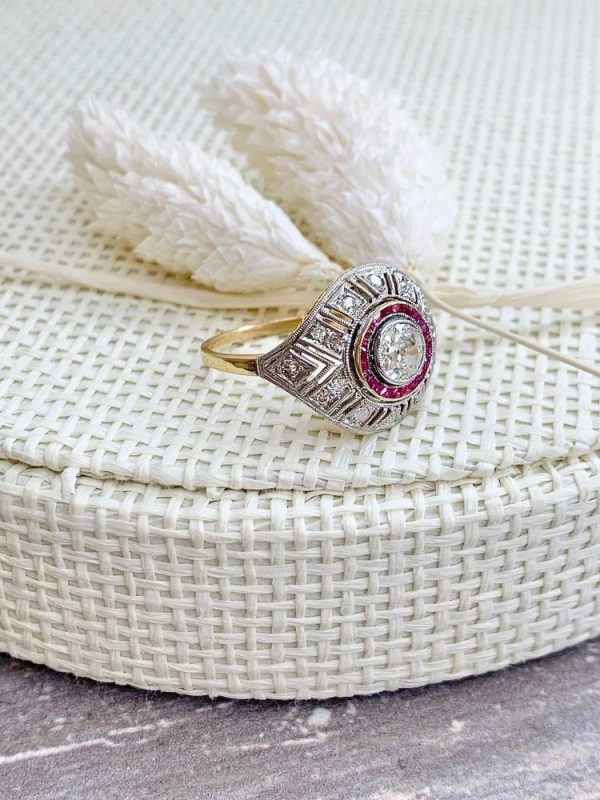 Art Deco diamond and ruby target ring in yellow and white gold.