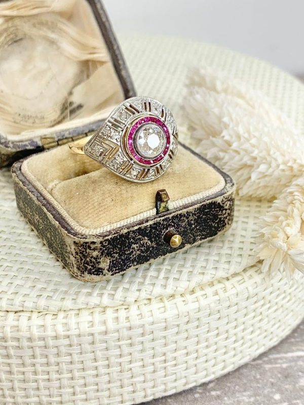 Art Deco diamond and ruby target ring in yellow and white gold.