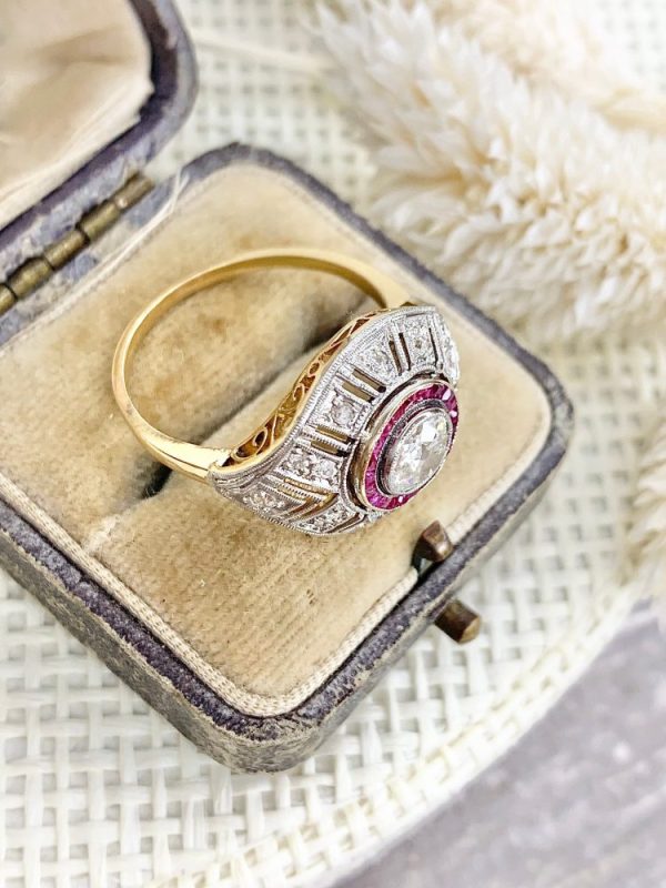 Art Deco diamond and ruby target ring in yellow and white gold.