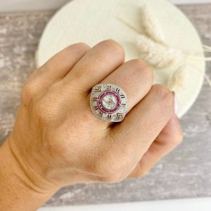 Art Deco diamond and ruby target ring in yellow and white gold.