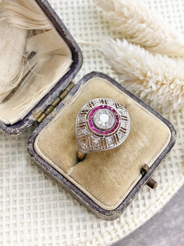 Art Deco diamond and ruby target ring in yellow and white gold.