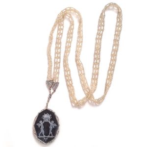 Antique Onyx and Rock Crystal Intaglio Pendant on Seed Pearl Sautoir Necklace, long geometric strung seed pearls suspends oval black onyx and rock crystal intaglio pendant featuring two winged cherubs holding aloft  flowers in an urn