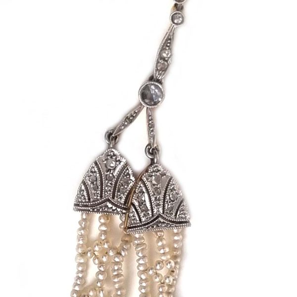 Antique Onyx and Rock Crystal Intaglio Pendant on Seed Pearl Sautoir Necklace, long geometric strung seed pearls suspends oval black onyx and rock crystal intaglio pendant featuring two winged cherubs holding aloft  flowers in an urn