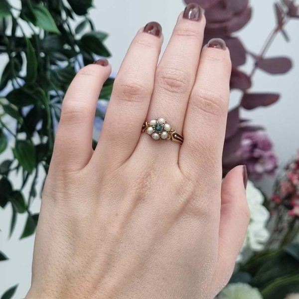 Georgian Antique Emerald and Pearl Cluster Ring, emerald surrounded by pearls in timeless floral cluster design in yellow gold accented with scrolled shoulders and gold granule detailing and locket compartment to reverse