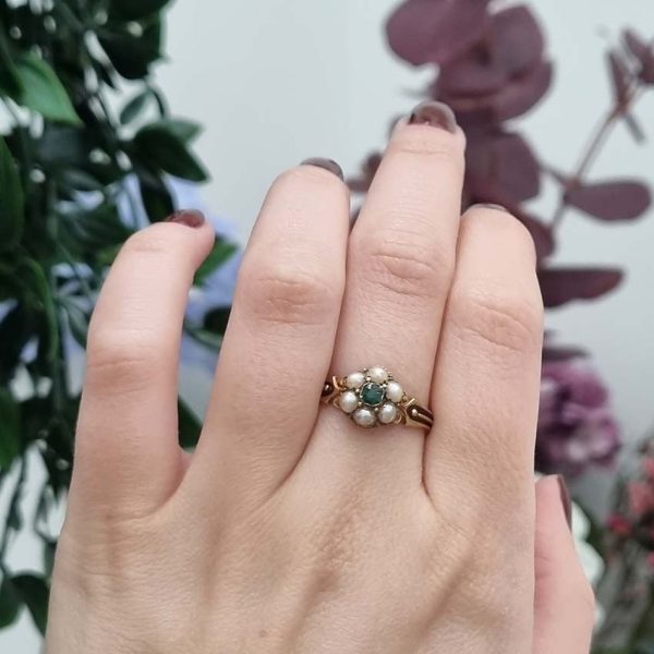 Georgian Antique Emerald and Pearl Cluster Ring, emerald surrounded by pearls in timeless floral cluster design in yellow gold accented with scrolled shoulders and gold granule detailing and locket compartment to reverse