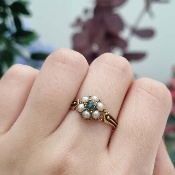 Georgian Antique Emerald and Pearl Cluster Ring, emerald surrounded by pearls in timeless floral cluster design in yellow gold accented with scrolled shoulders and gold granule detailing and locket compartment to reverse