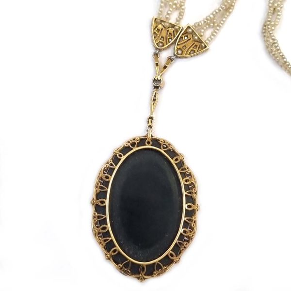 Antique Onyx and Rock Crystal Intaglio Pendant on Seed Pearl Sautoir Necklace, long geometric strung seed pearls suspends oval black onyx and rock crystal intaglio pendant featuring two winged cherubs holding aloft  flowers in an urn