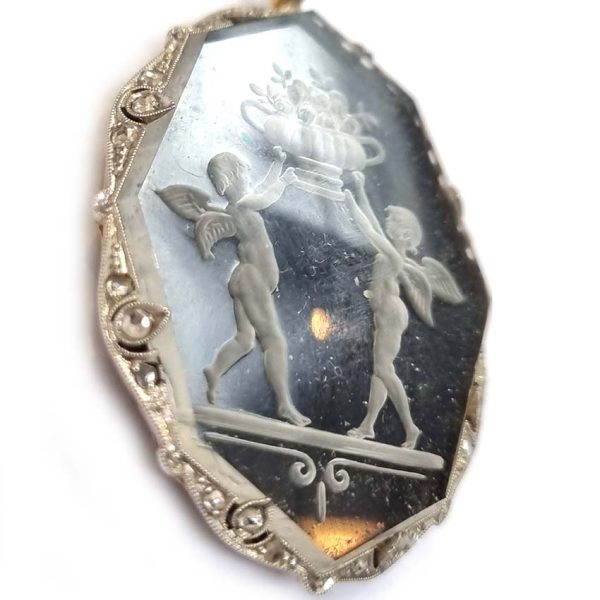 Antique Onyx and Rock Crystal Intaglio Pendant on Seed Pearl Sautoir Necklace, long geometric strung seed pearls suspends oval black onyx and rock crystal intaglio pendant featuring two winged cherubs holding aloft  flowers in an urn
