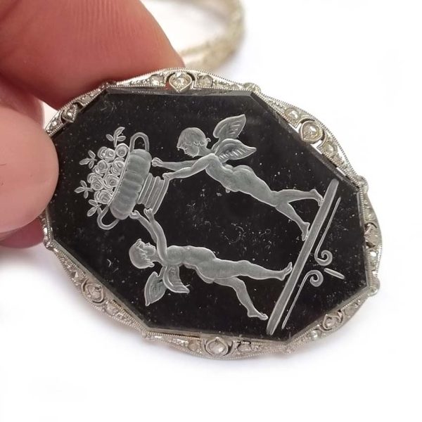 Antique Onyx and Rock Crystal Intaglio Pendant on Seed Pearl Sautoir Necklace, long geometric strung seed pearls suspends oval black onyx and rock crystal intaglio pendant featuring two winged cherubs holding aloft  flowers in an urn