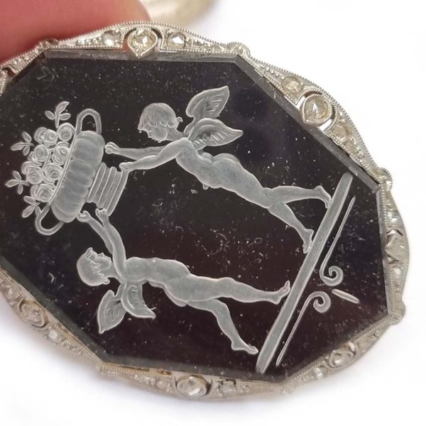 Antique Onyx and Rock Crystal Intaglio Pendant on Seed Pearl Sautoir Necklace, long geometric strung seed pearls suspends oval black onyx and rock crystal intaglio pendant featuring two winged cherubs holding aloft  flowers in an urn